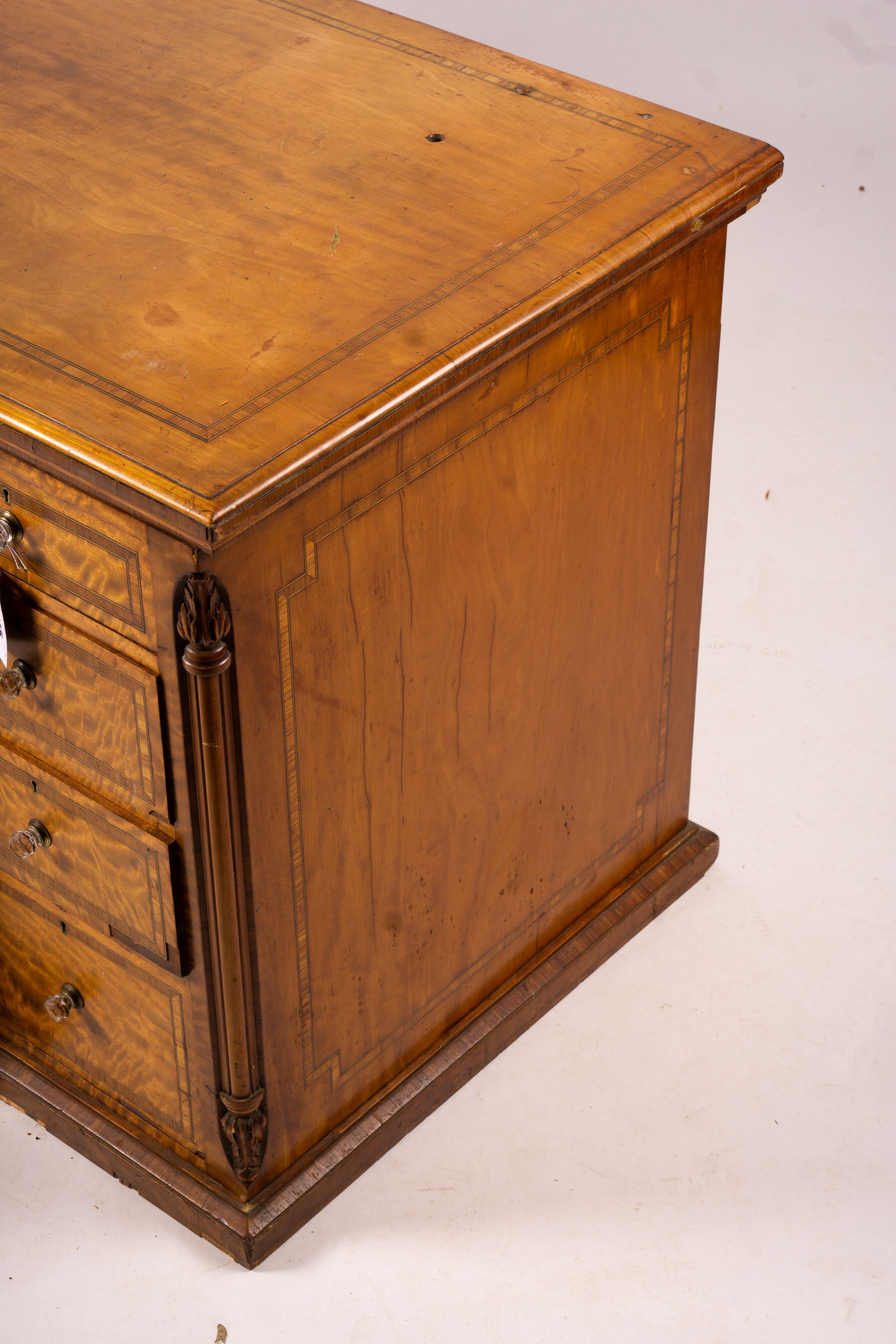 A late Victorian banded satinwood kneehole desk, width 138cm, depth 67cm, height 71cm